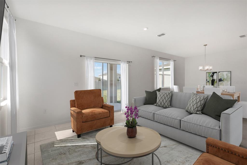 A living room features a gray sofa, two brown armchairs, and a sliding glass door — 877 CASTLEFORD AVENUE NE, PALM BAY, FL