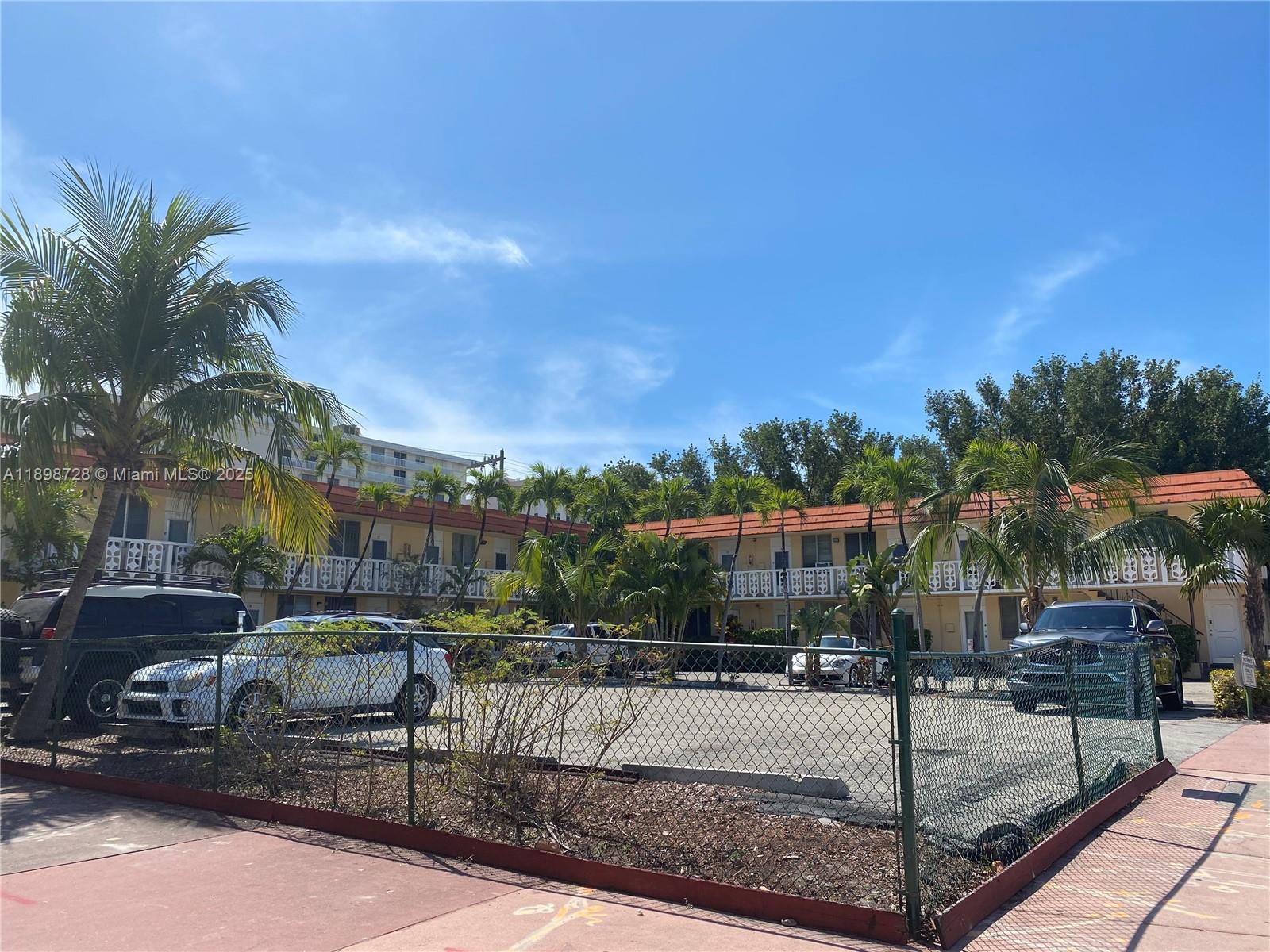 A two-story apartment complex with a parking lot enclosed by a chain-link fence — 441 Collins Ave # 27, Miami Beach FL 33139, MIAMI BEACH, FL