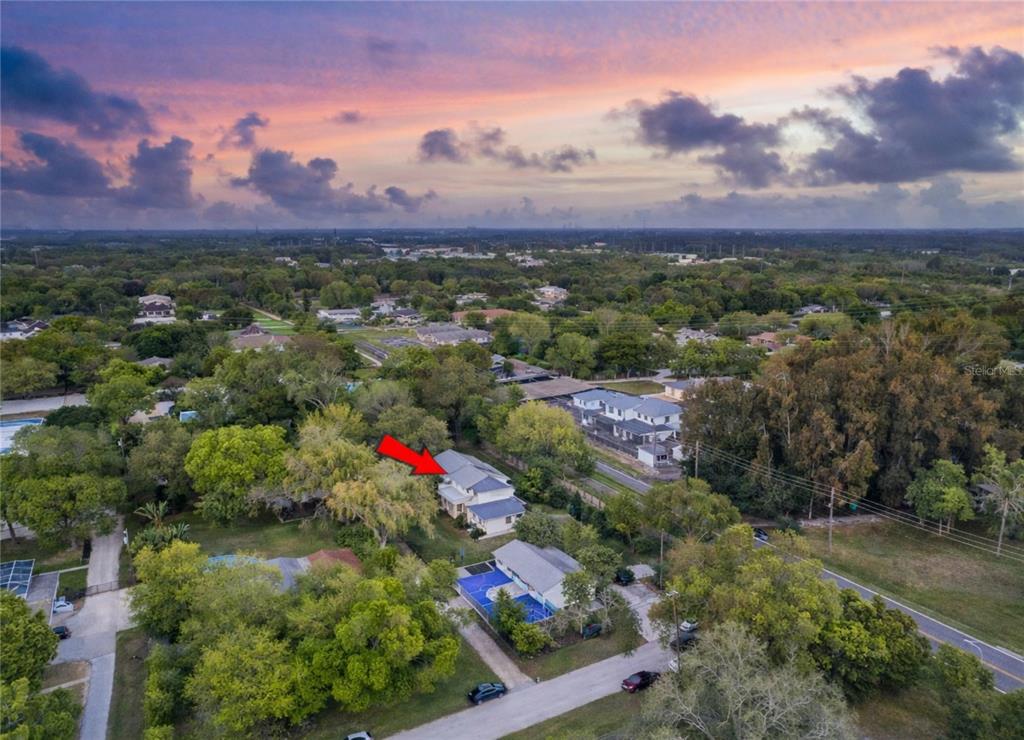 An aerial view shows a residential house with a red arrow pointing to it — 10852 131ST STREET N, LARGO, FL