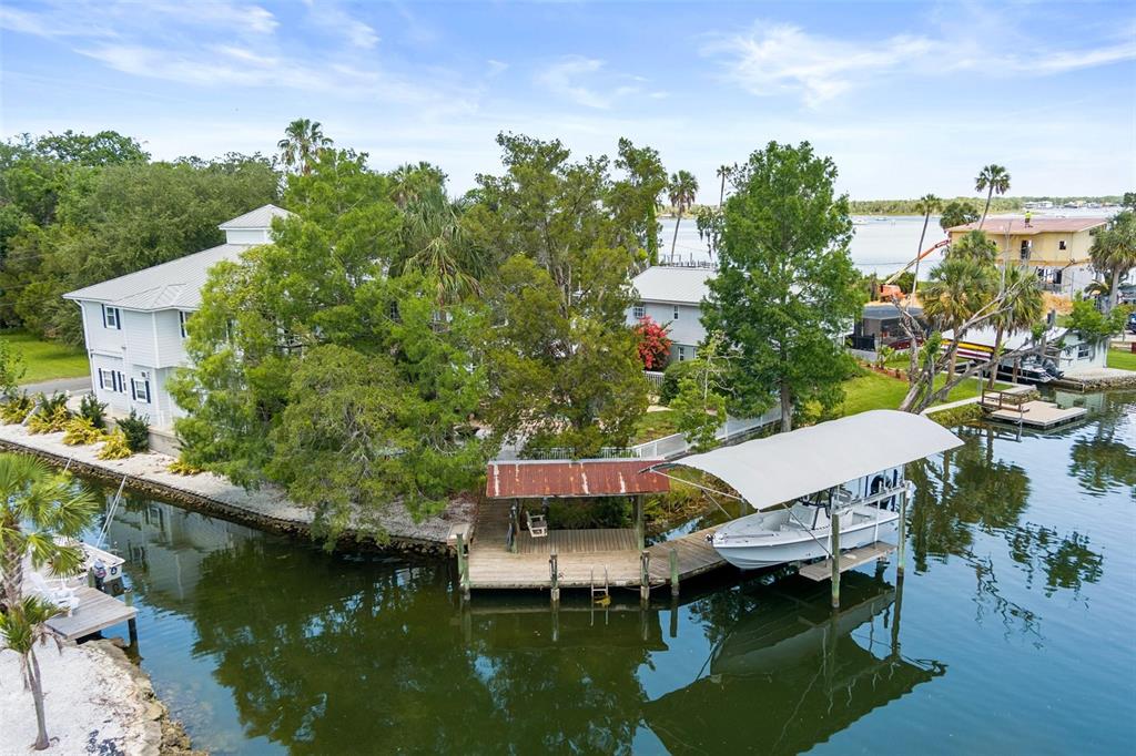 An aerial view shows a waterfront house with a boat dock and covered lift — 1035 N APPALACHIAN TERRACE, CRYSTAL RIVER, FL