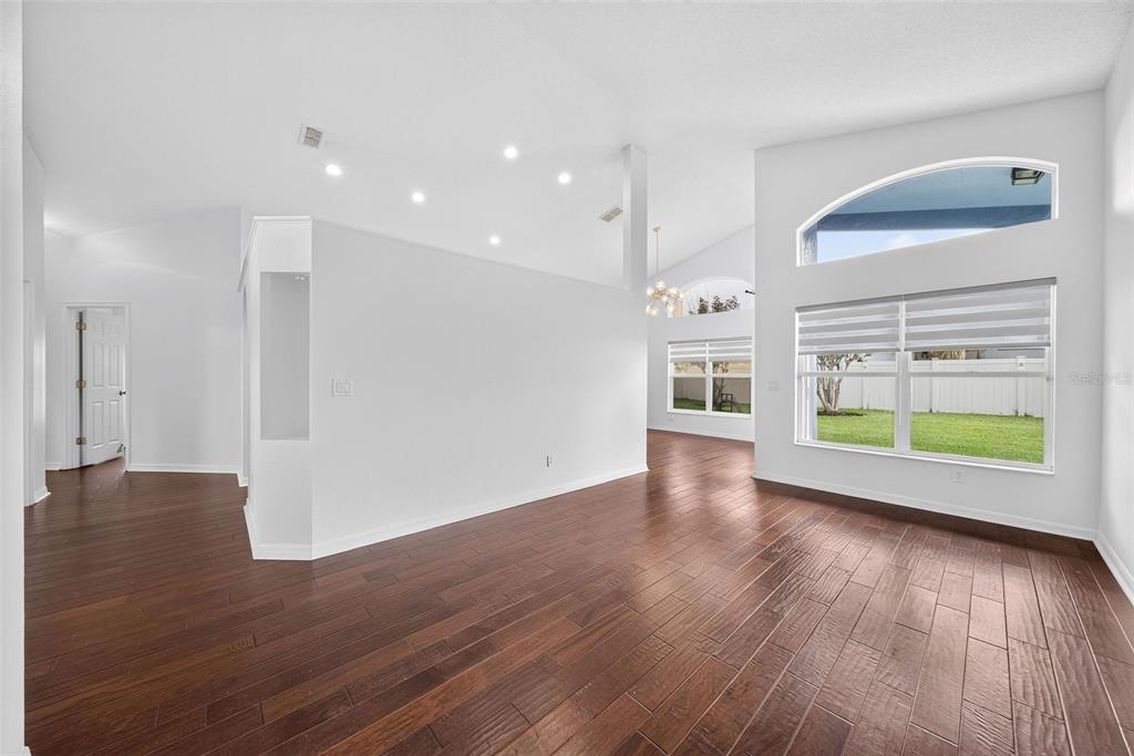 A bright living area with dark hardwood floors, high ceilings, and large windows — 630 RIOMAR AVENUE, ORLANDO, FL