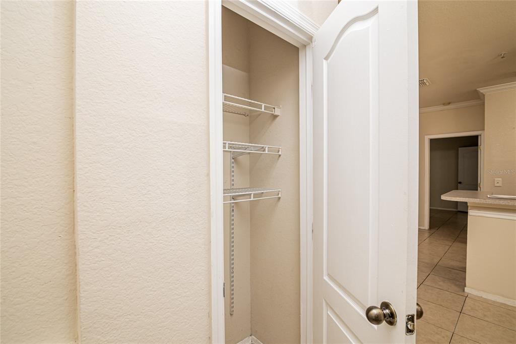 An open door reveals a small closet with three white wire shelves — 3391 S KIRKMAN ROAD UNIT 1216, ORLANDO, FL