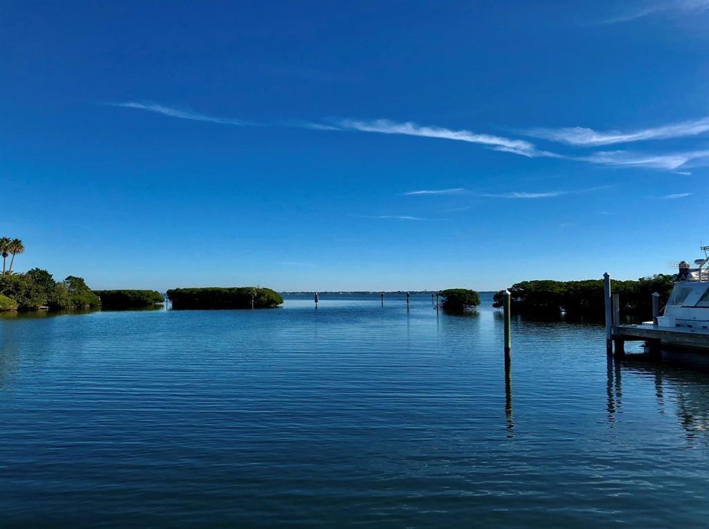 A view of a calm bay with mangroves and a boat dock under a blue sky — 2600 HARBOURSIDE DRIVE UNIT R-07, LONGBOAT KEY, FL