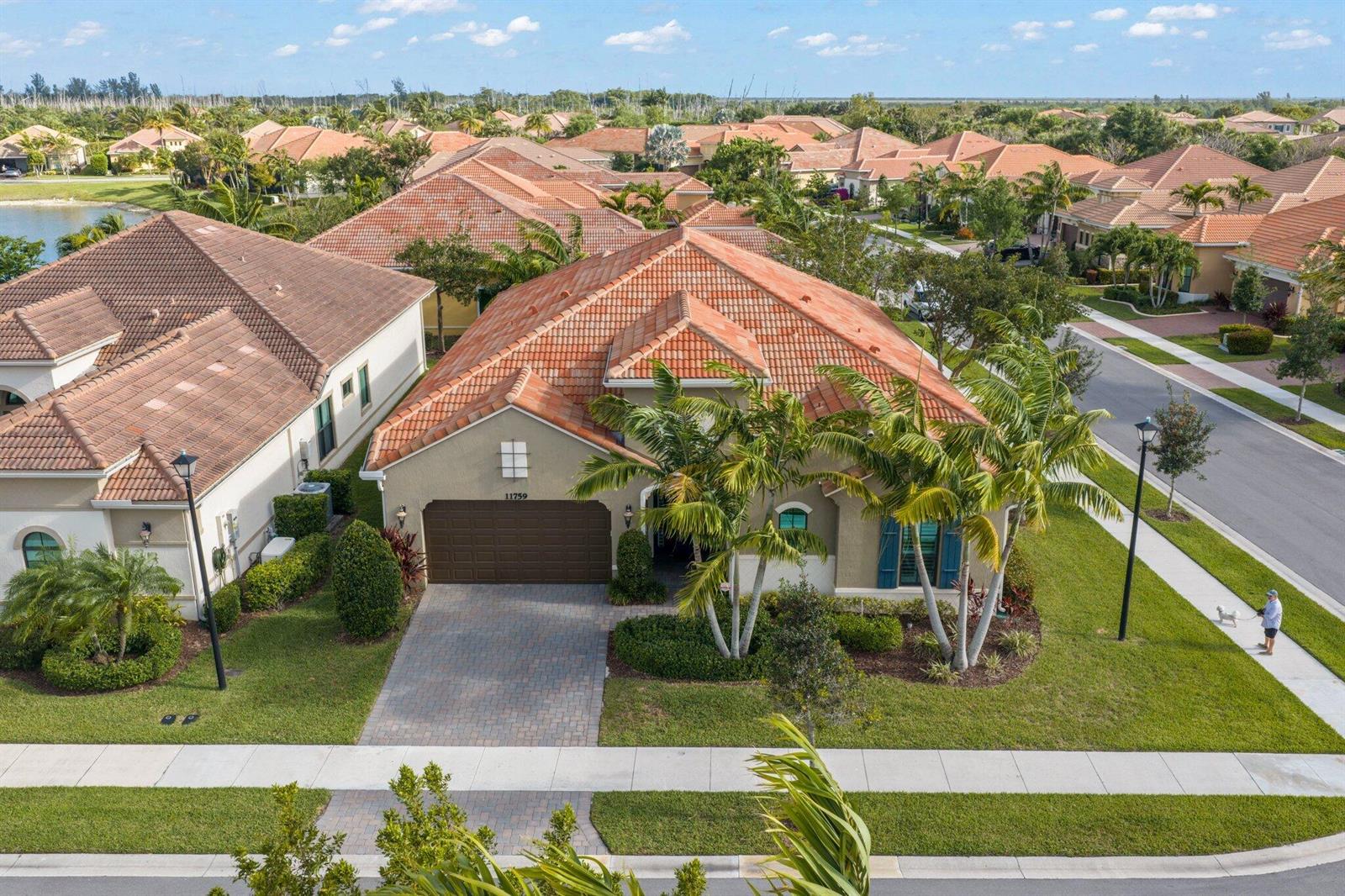 An aerial view of a single-story house with a tile roof and a paved driveway — 11759 Palermo Road, Parkland FL 33076, PARKLAND, FL