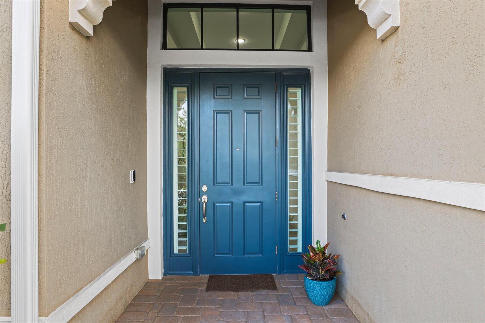 A blue front door with sidelights and a transom window sits in a covered entryway — 11759 Palermo Road, Parkland FL 33076, PARKLAND, FL