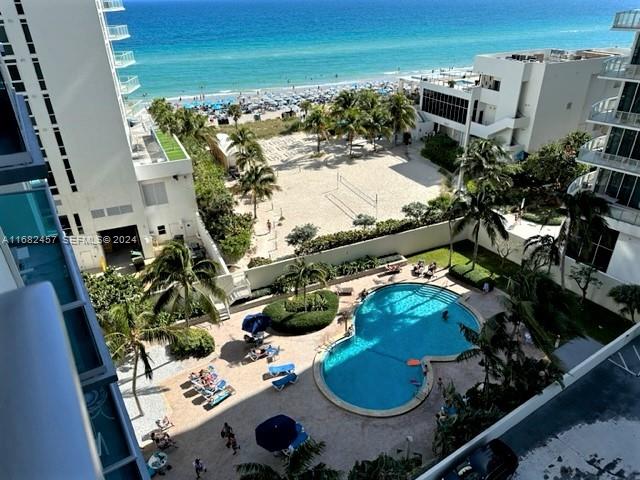 An elevated view shows a swimming pool, sandy beach area, and oceanfront buildings — 4001 S Ocean Dr # 9L, Hollywood FL 33019, HOLLYWOOD, FL