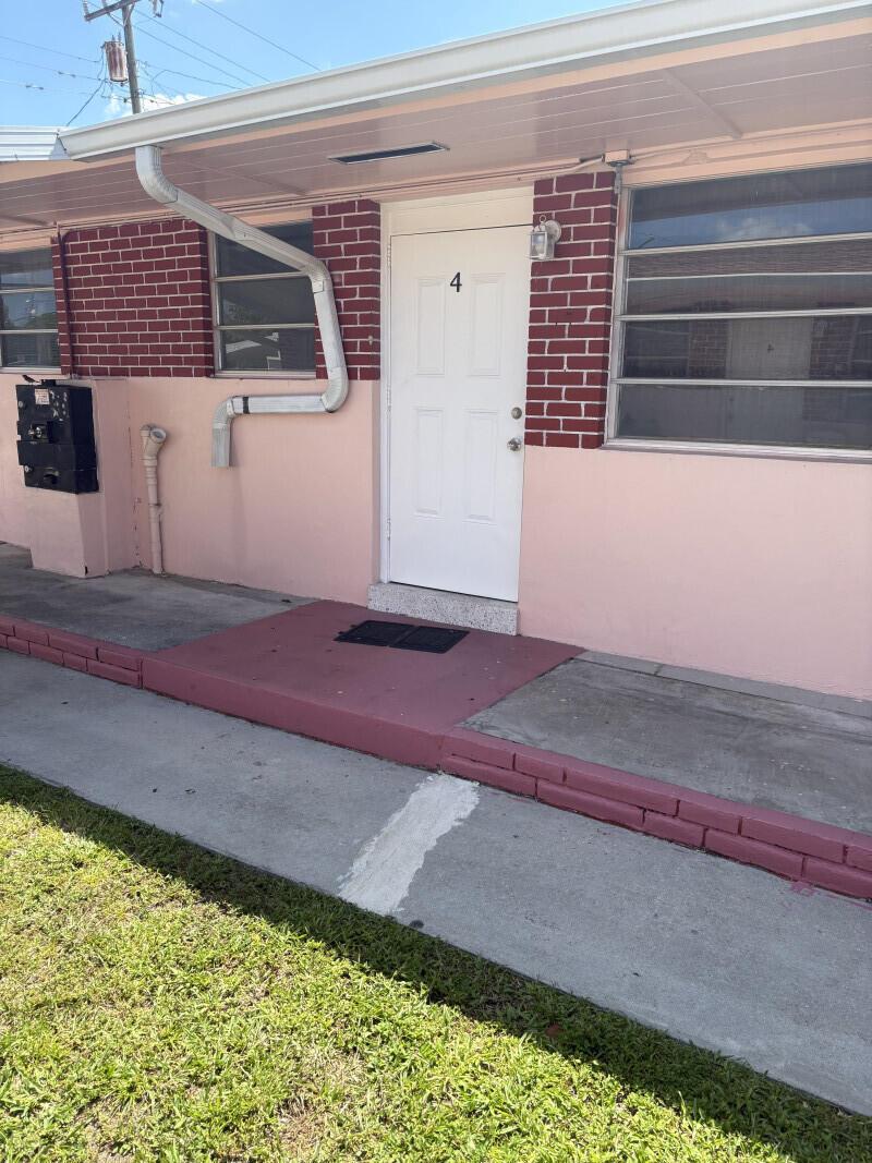 The exterior of a single-story building features a white door labeled four and brick accents — 66 W 10th Street # 4, Hialeah FL 33010, HIALEAH, FL
