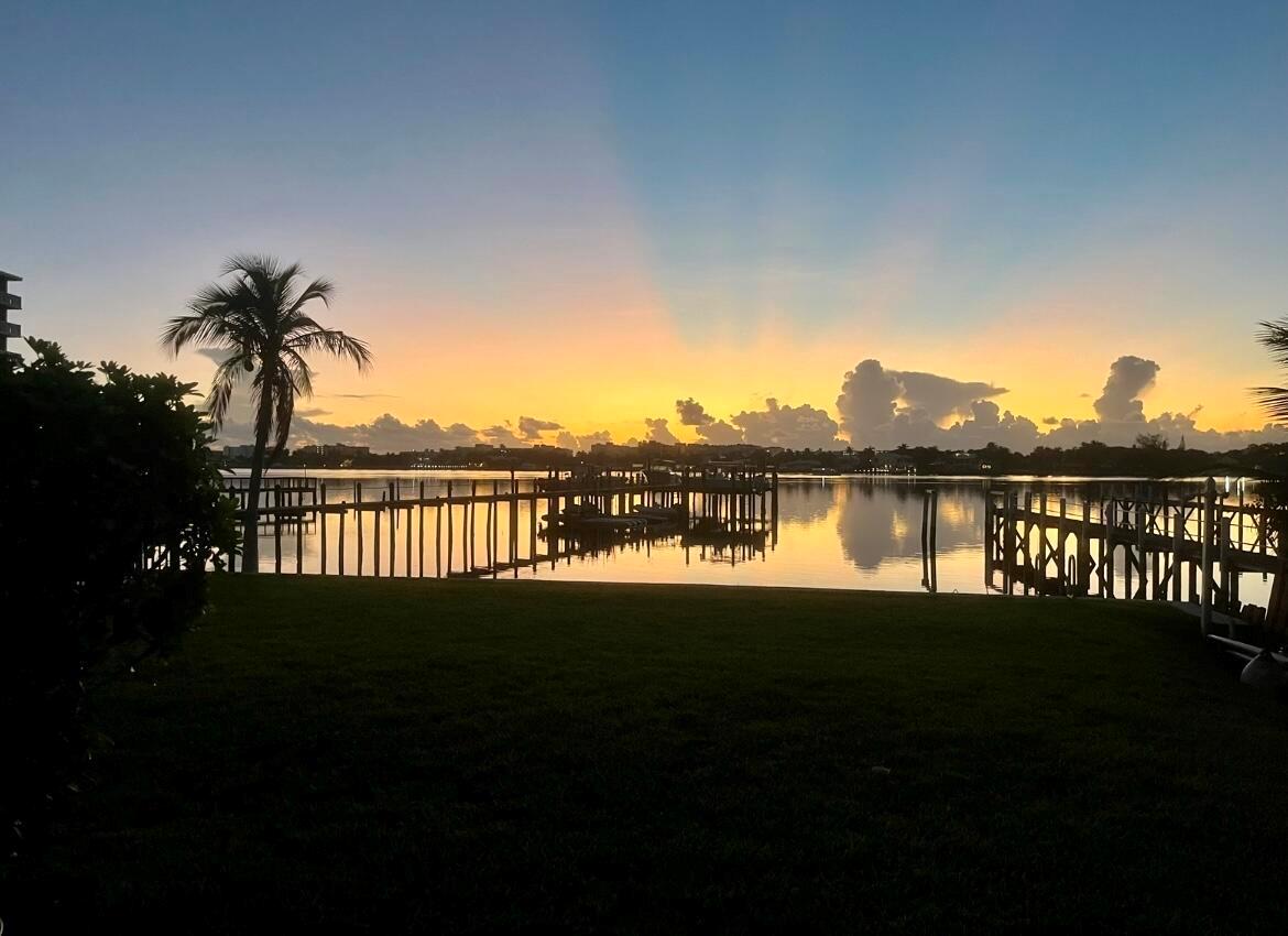 A sunset view over a calm bay with wooden docks and a palm tree — 324 N Lake Drive, Lantana FL 33462, LANTANA, FL