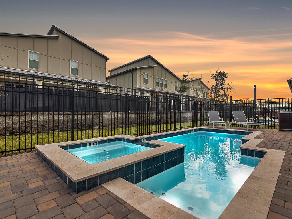 A backyard swimming pool and hot tub with a paver patio and black metal fence — 475 Strand Drive, Melbourne Beach FL 32951, MELBOURNE BEACH, FL