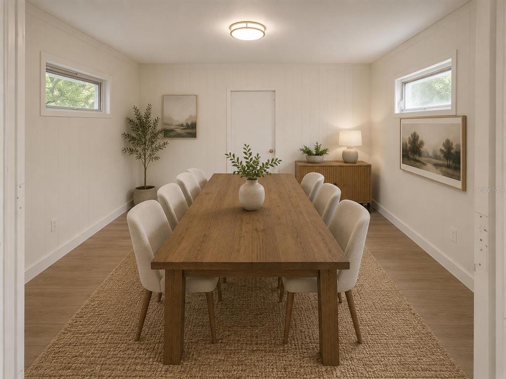 A dining room features a long wooden table with eight chairs on a jute rug — 517 MOROCCO AVENUE, ORLANDO, FL
