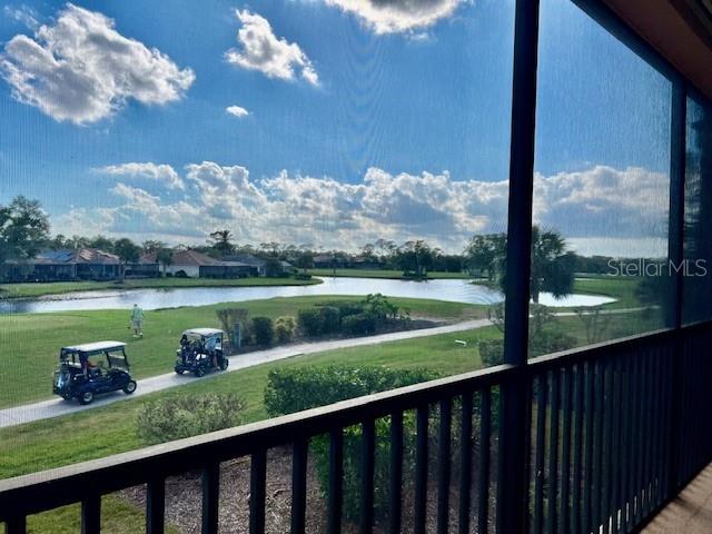 A view of a golf course and pond from a screened-in balcony — 24417 BALTIC AVENUE UNIT 1102, PUNTA GORDA, FL