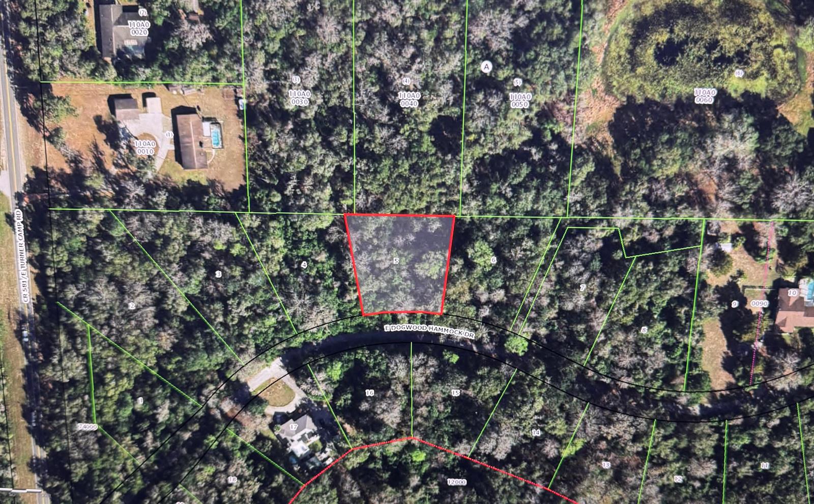 This is an aerial map showing a highlighted vacant lot surrounded by trees and residential properties — 6761 E Dogwood Hammock Drive, Inverness FL 34453, INVERNESS, FL