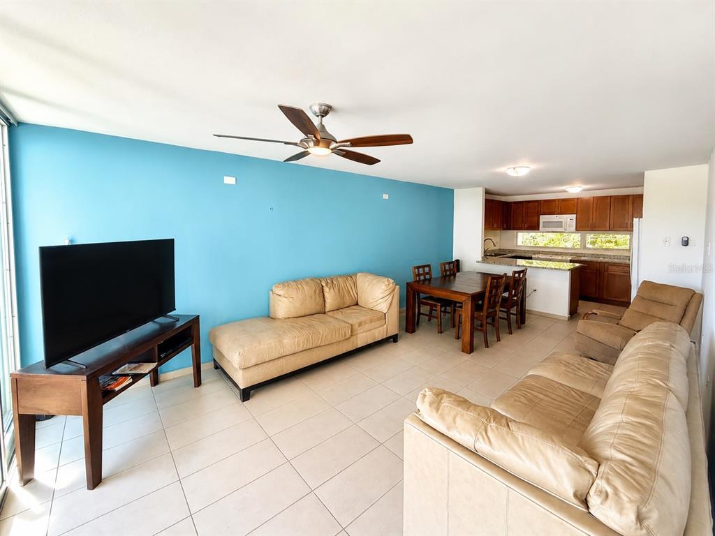 An open-concept living and dining area features a blue accent wall and tile flooring — 1554 CALLE LÓPEZ LANDRÓN apt #301, SAN JUAN, PR