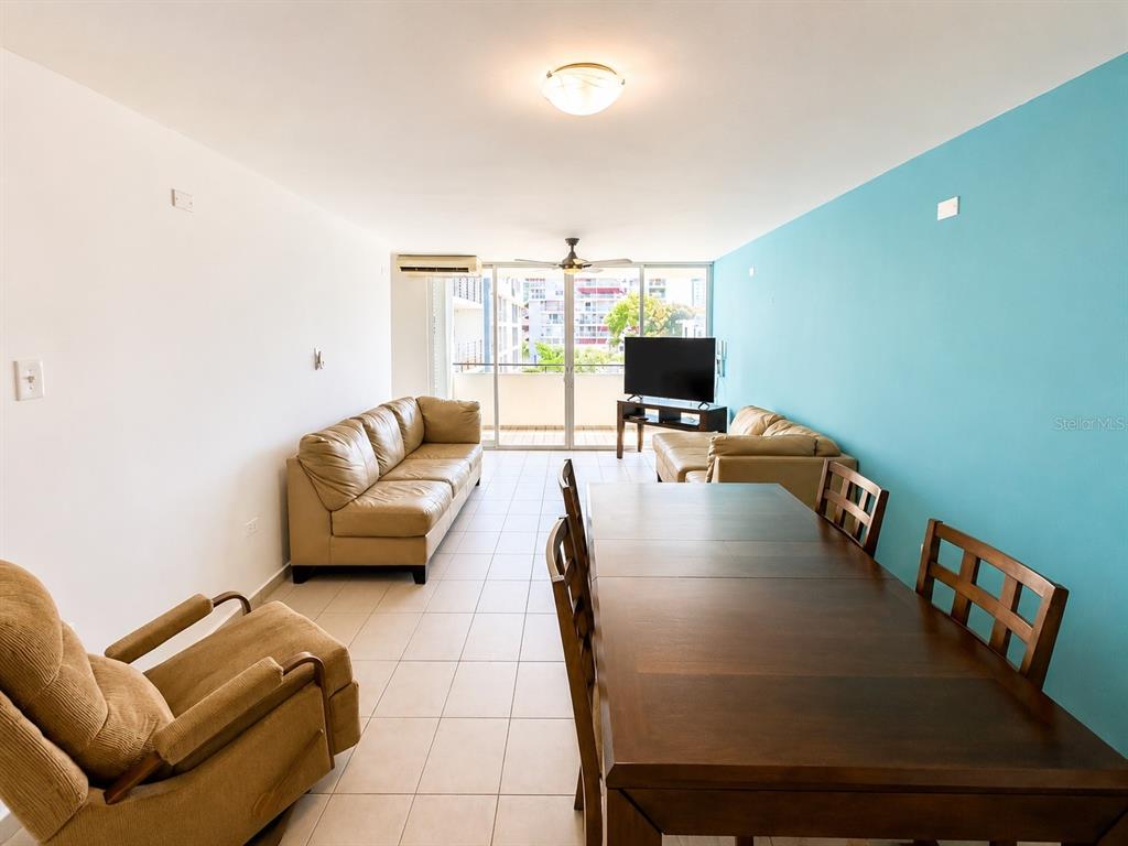 A living and dining area features tile floors, a blue accent wall, and a balcony — 1554 CALLE LÓPEZ LANDRÓN apt #301, SAN JUAN, PR