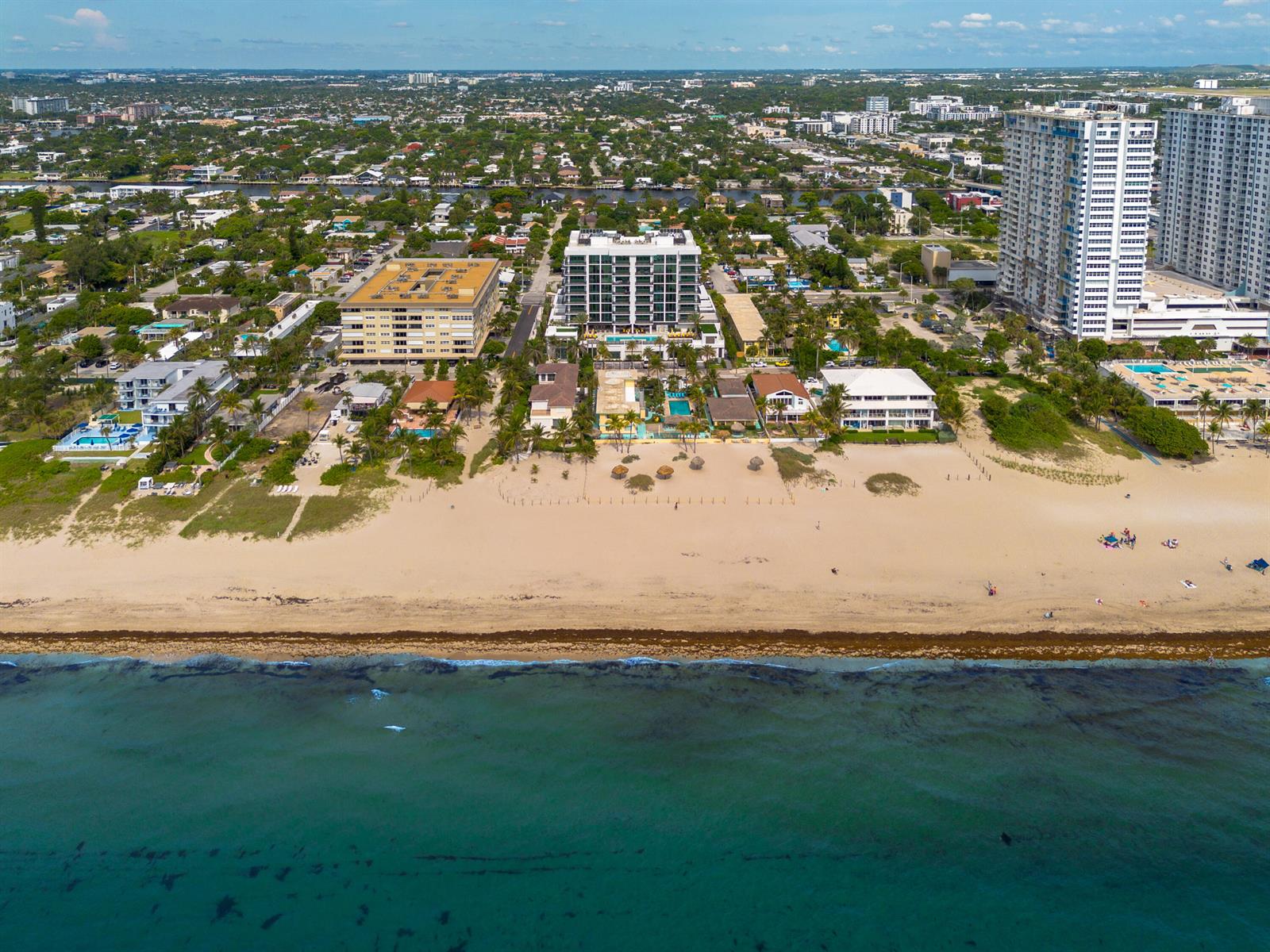 Aerial view of a beach with hotels and residential buildings along the coastline — 305 Briny Avenue # 506, Pompano Beach FL 33062, POMPANO BEACH, FL