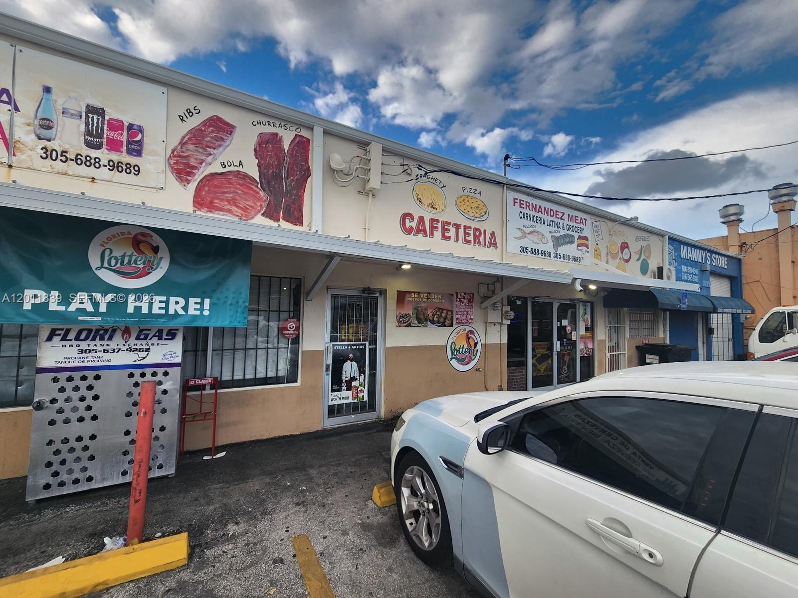 The exterior of a commercial building features a cafeteria, meat market, and convenience store — 4125 E 10th Ct, Hialeah FL 33013, HIALEAH, FL
