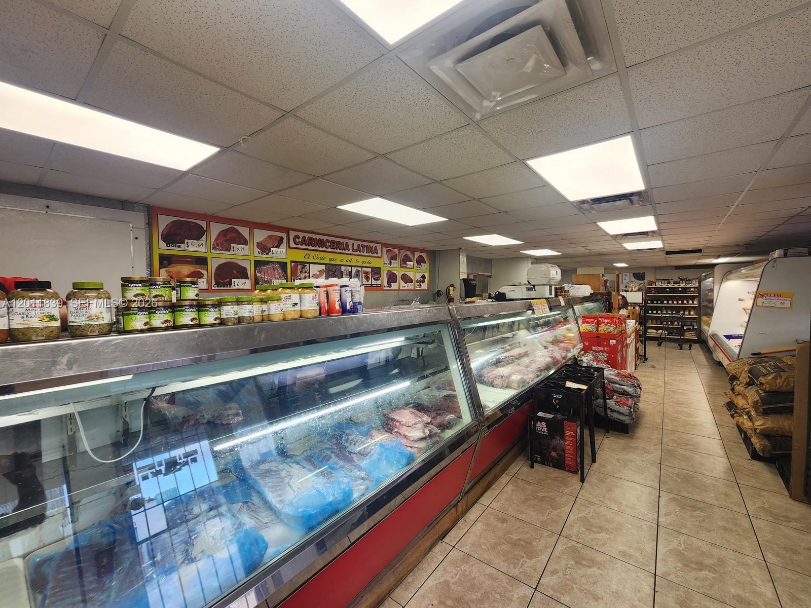 A butcher shop interior features refrigerated display cases, tiled floors, and a meat selection sign — 4125 E 10th Ct, Hialeah FL 33013, HIALEAH, FL