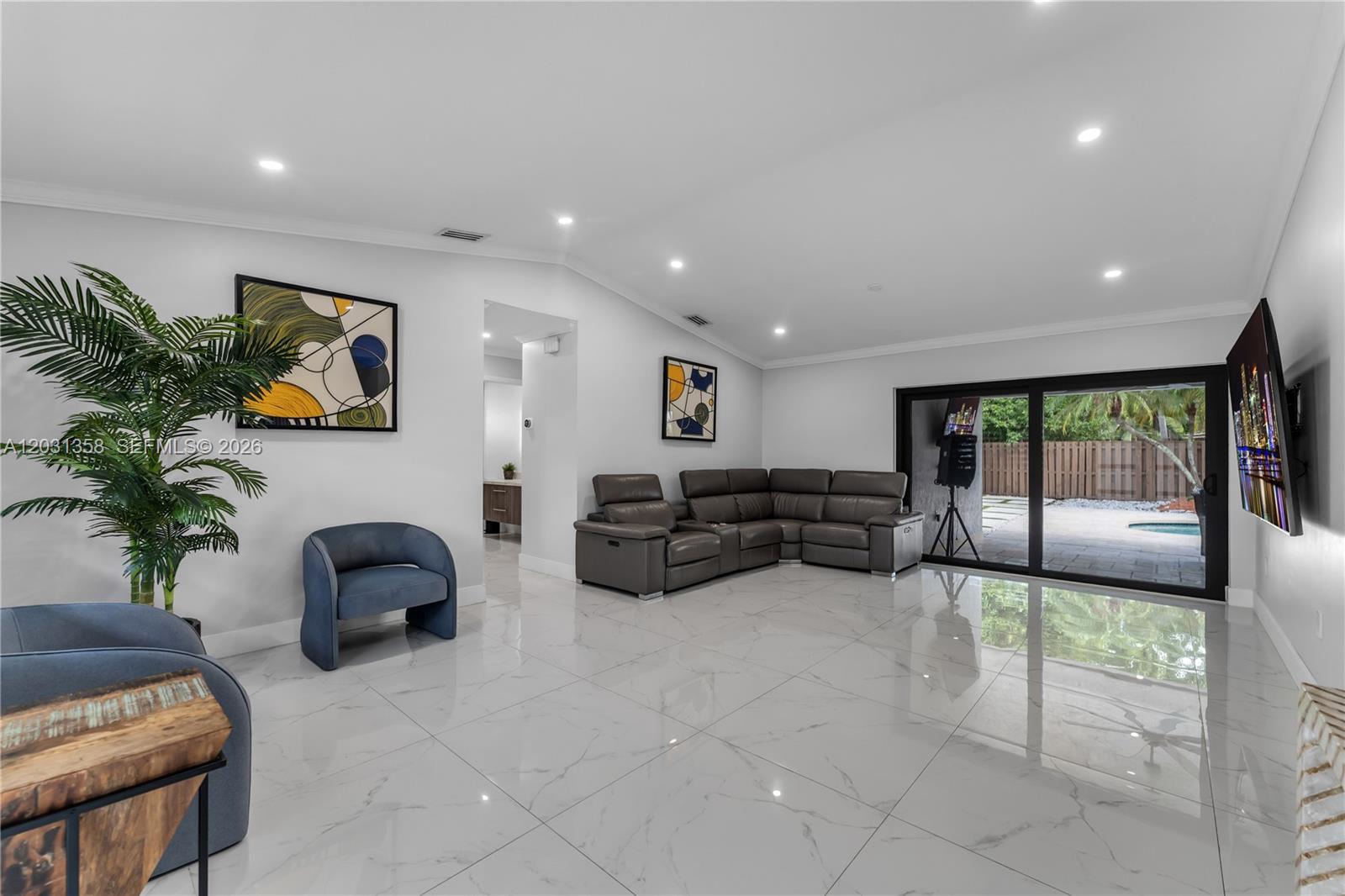 A living room features white marble floors, a grey sectional sofa, and sliding glass doors — 15842 SW 105th St, Miami FL 33196, MIAMI, FL