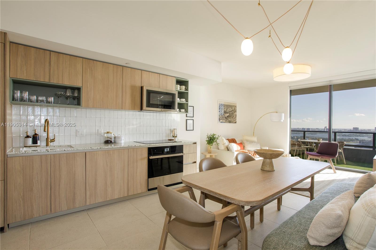 A modern kitchen and dining area feature light wood cabinetry, white tile, and balcony views — 159 NE 6th St # 2816, Miami FL 33132, MIAMI, FL