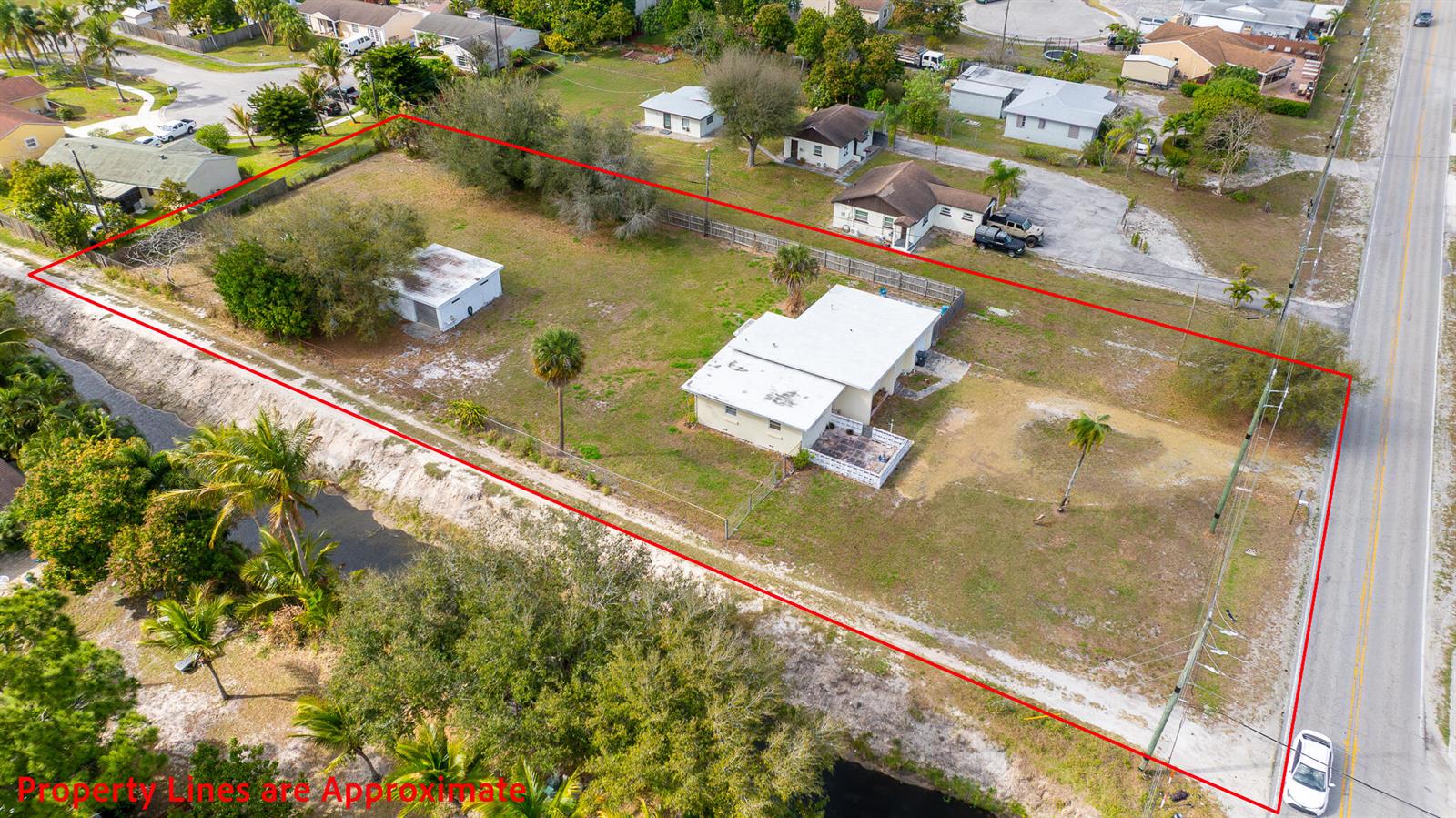 An aerial view shows a residential lot with a house, a detached garage, and trees — 4475 Kirk Road, Lake Worth FL 33461, LAKE WORTH, FL
