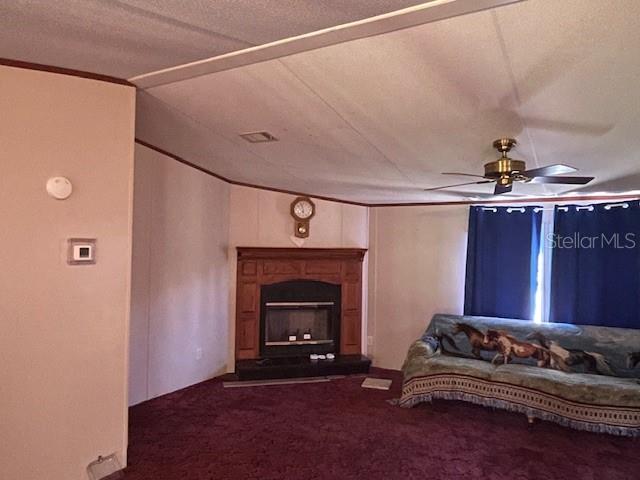 A living room features a fireplace, a ceiling fan, and a sofa with a horse-patterned throw — 7196 NW 205TH STREET, ALACHUA, FL