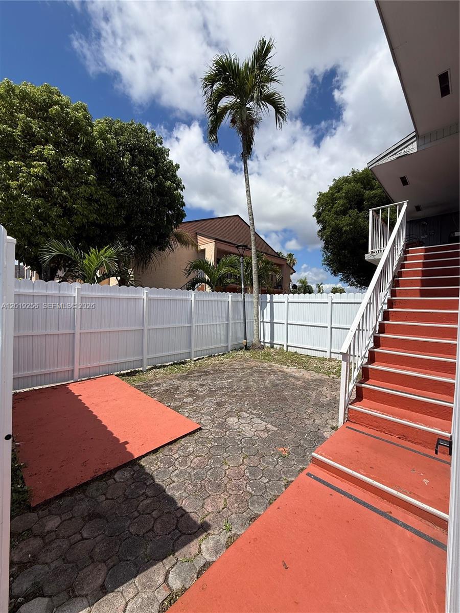 A paved patio area features a red platform and stairs leading to an upper level — 8480 SW 156th Pl # 620, Miami FL 33193, MIAMI, FL