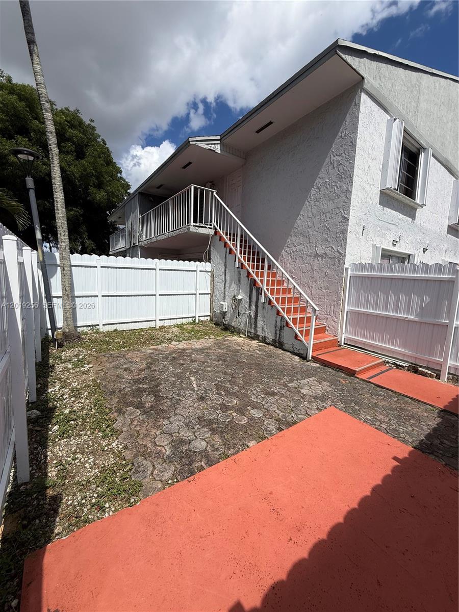 An exterior view shows a two-story building with an outdoor staircase leading to a balcony — 8480 SW 156th Pl # 620, Miami FL 33193, MIAMI, FL