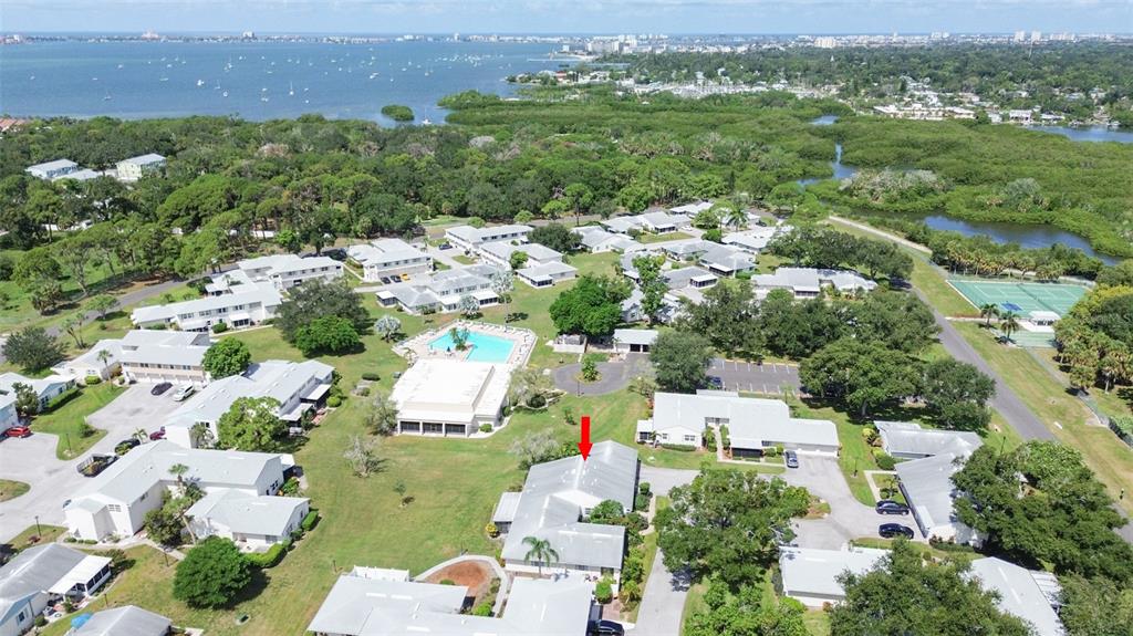 An aerial view of a residential complex with a red arrow pointing to a specific unit — 3216 39TH STREET UNIT C, ST PETERSBURG, FL