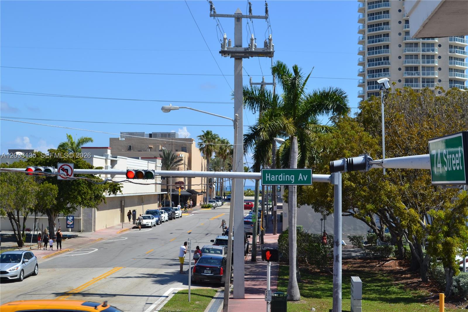 A street-level view shows a road intersection with traffic lights, street signs, and palm trees — 300 74th St # 5, Miami Beach FL 33141, MIAMI BEACH, FL