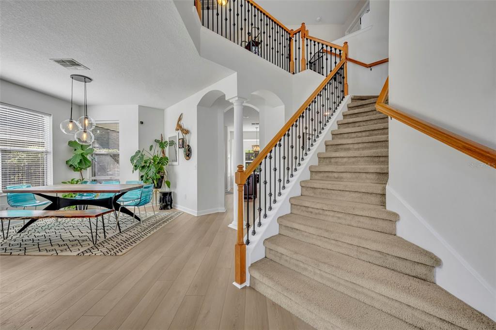A screened-in patio features a swimming pool, outdoor dining set, and white lounge chairs — 2329 NATOMA BLVD, MOUNT DORA, FL
