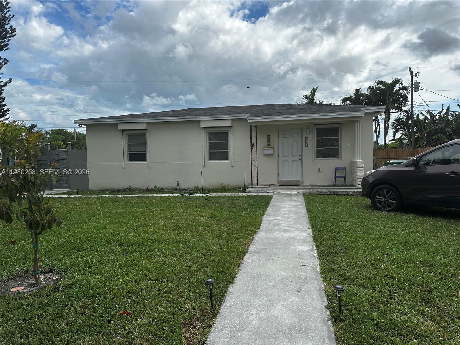 A single-story house with a beige exterior, a front walkway, and a parked car — 7540 SW 37th St, Miami FL 33155, MIAMI, FL