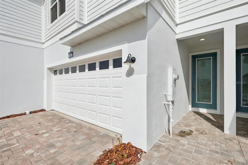 A white garage door and a blue front door are visible on this house exterior — 31477 SPANISH MISSION ROAD, SAN ANTONIO, FL