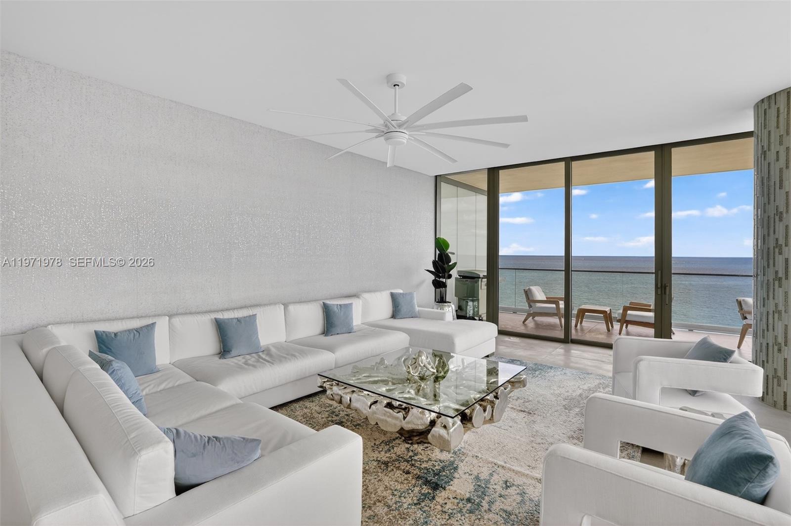 A living room features a large white sectional, glass coffee table, and oceanfront balcony views — 2000 S Ocean Dr # 14B, Hallandale Beach FL 33009, HALLANDALE BEACH, FL