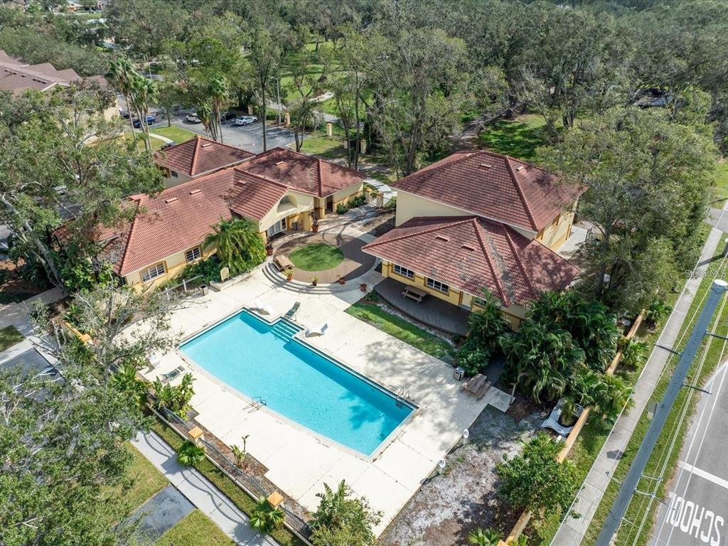 An aerial view of a swimming pool and two buildings with terracotta-tiled roofs — 5606 PINNACLE HEIGHTS CIRCLE UNIT 306, TAMPA, FL