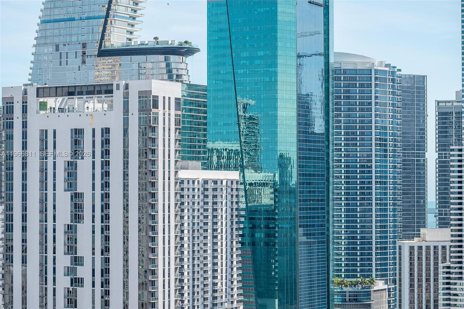 A view of several modern high-rise skyscrapers in a dense urban city skyline — 225 N Miami Ave # 3307, Miami FL 33128, MIAMI, FL