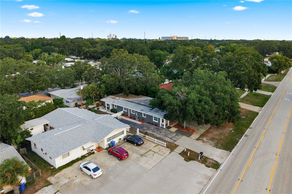 An aerial view shows a white house with a gray roof and a paved driveway — 536 PATRICIA AVENUE, DUNEDIN, FL