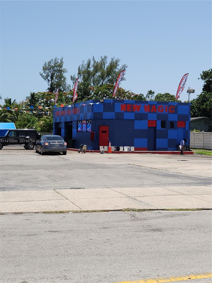 A blue and red checkered car wash building stands on a paved lot — 4420 NW 7th Ave, Miami FL 33127, MIAMI, FL
