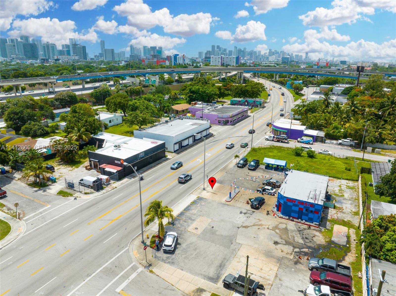 An aerial view shows a commercial property with a parking lot near a highway — 4420 NW 7th Ave, Miami FL 33127, MIAMI, FL