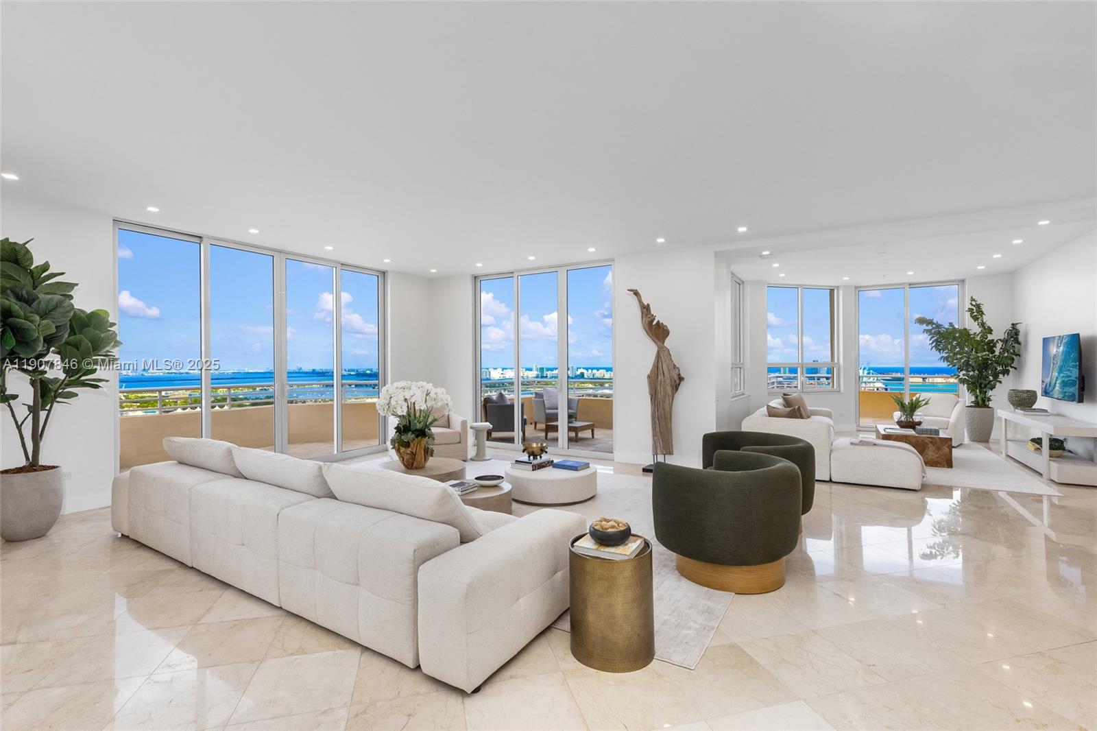 A bright, open-concept living room features marble floors, floor-to-ceiling windows, and panoramic ocean views — 808 Brickell Key Dr # 3901, Miami FL 33131, MIAMI, FL