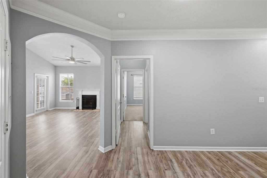 A view from a room into a living area with a fireplace and a hallway — 10504 VILLA VIEW CIRCLE, TAMPA, FL