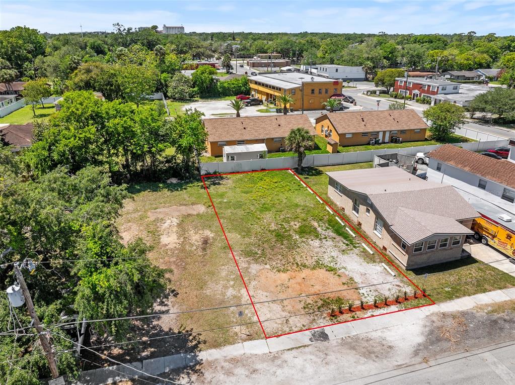 An aerial view shows a vacant rectangular lot outlined in red next to a house — 254 JEFFERSON STREET, DAYTONA BEACH, FL