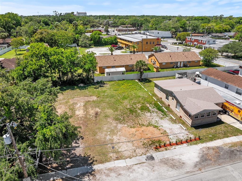 An aerial view shows a vacant grassy lot adjacent to a single-story residential building — 254 JEFFERSON STREET, DAYTONA BEACH, FL