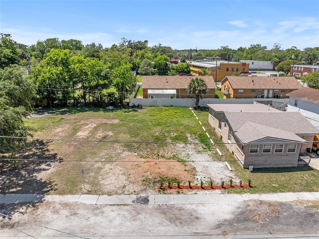 An elevated view shows a vacant, grassy lot adjacent to a single-story residential building — 254 JEFFERSON STREET, DAYTONA BEACH, FL