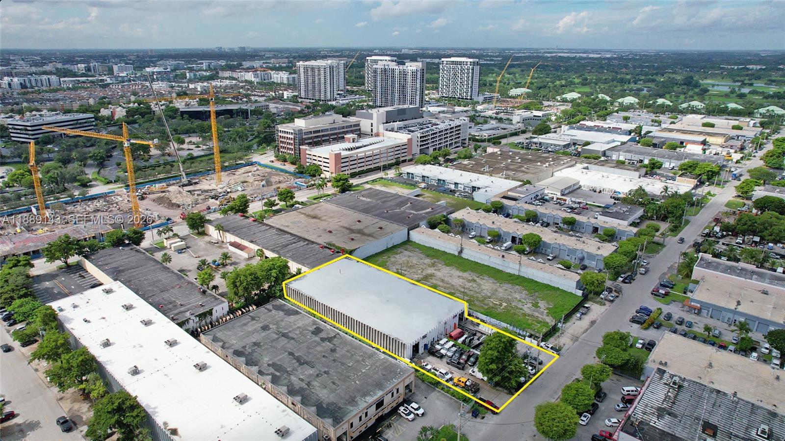 An aerial view shows a rectangular warehouse building highlighted in yellow within an industrial area — 8230 NW 56th St, Doral FL 33166, DORAL, FL