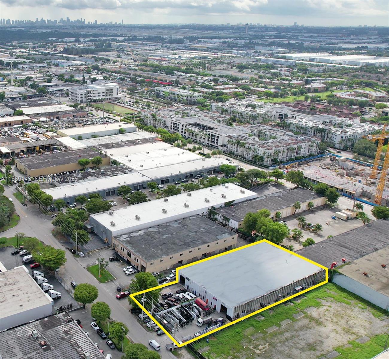 An aerial view shows a rectangular industrial warehouse building highlighted with a yellow outline — 8230 NW 56th St, Doral FL 33166, DORAL, FL