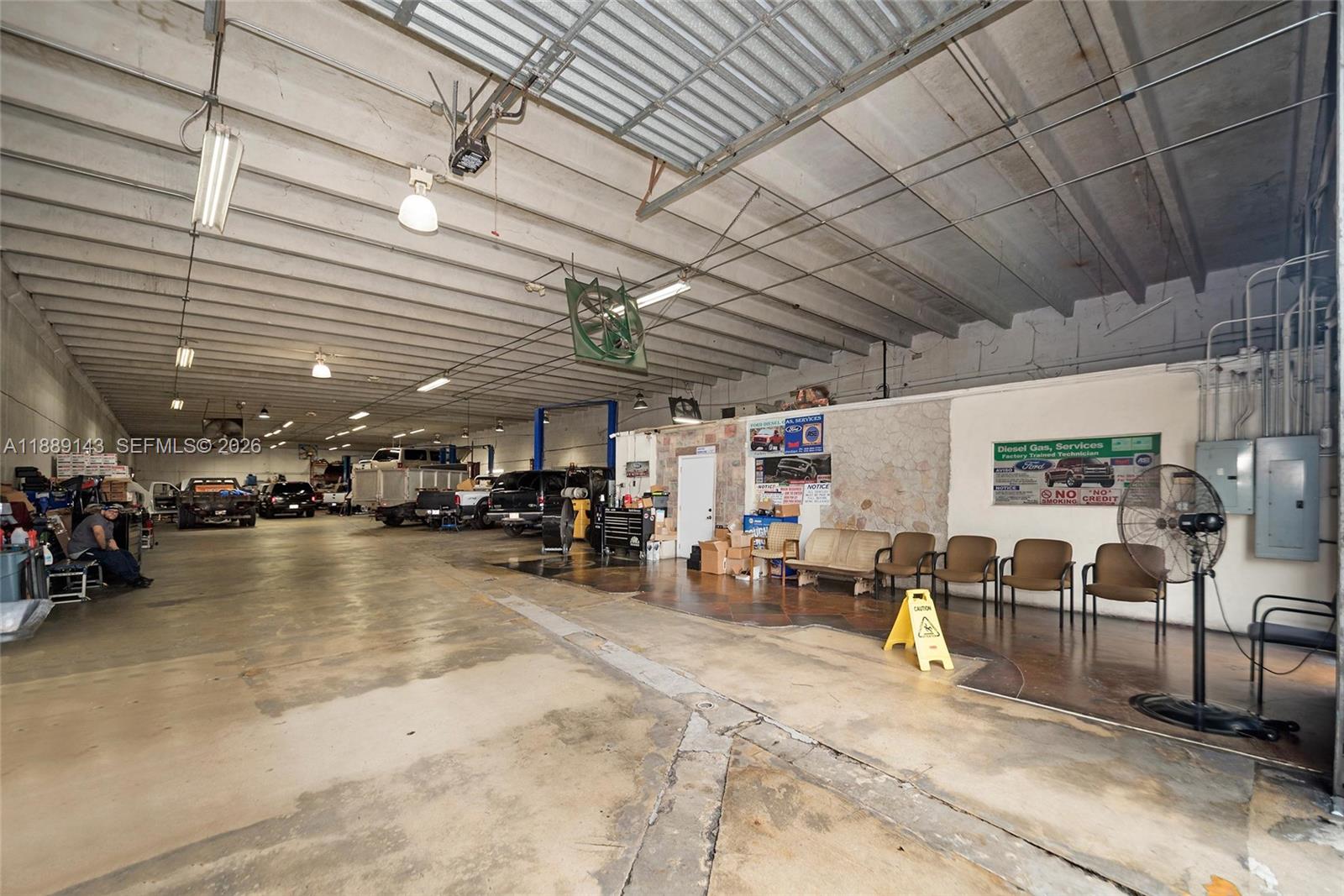 This large industrial garage features concrete floors, exposed ceiling beams, and a waiting area — 8230 NW 56th St, Doral FL 33166, DORAL, FL