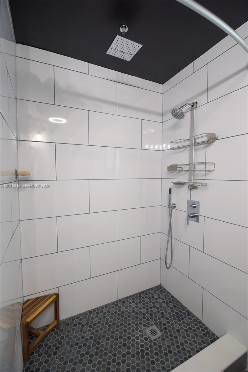 A walk-in shower features white subway tile walls, a dark ceiling, and a hexagonal floor — 8356 NW 37th Pl # 9, Sunrise FL 33351, SUNRISE, FL