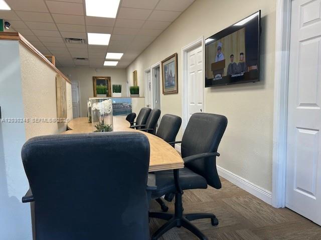 An office conference room features a long wooden table, black chairs, and a wall-mounted television — 7651 Davie Road Ext, Davie FL 33024, DAVIE, FL
