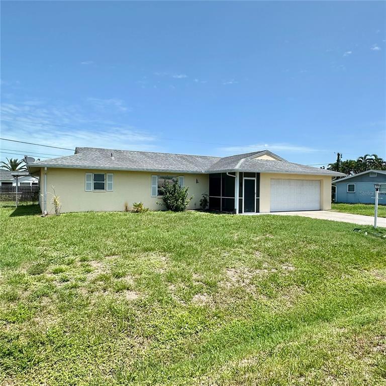 A single-story house with yellow siding, a gray shingled roof, and an attached garage — 340 PEARY ROAD, VENICE, FL