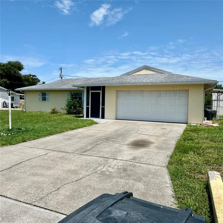 A single-story house with a yellow exterior, a concrete driveway, and a two-car garage — 340 PEARY ROAD, VENICE, FL